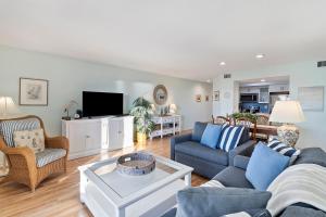 a living room with a couch and a tv at PW1357: 1357 Pelican Watch in Seabrook Island