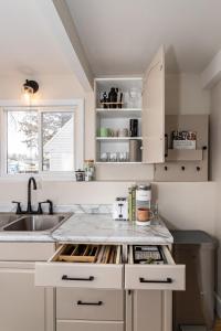 a kitchen with white cabinets and a sink at Modern 3BR Getaway-Stylish, Ames in Ames