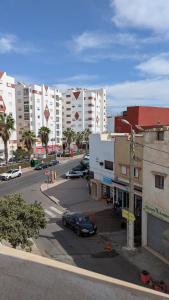 a city street with cars parked in a parking lot at city centre house Near to souk Elhad agadir in Agadir