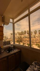 a kitchen with two windows and a view of a field at city centre house Near to souk Elhad agadir in Agadir +45 photos
