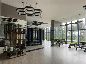 a large room with tables and benches and windows at The Arena Resort Beach Front View LightA-0441 in Cam Ranh International Airport