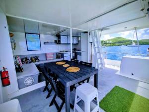 a kitchen and dining room on a boat at catamaran nautilodge in Sainte-Anne