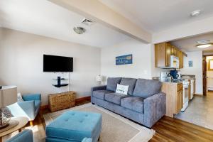 a living room with a couch and a kitchen at Bayside Haven in Ossipee