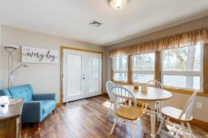 a living room with a table and chairs and a couch at Bayside Haven in Ossipee +18 photos