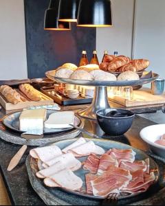 a table topped with plates of food and bread at LA BELLE IDEE in Nokere