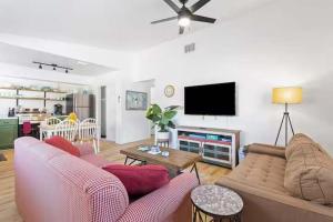 a living room with a couch and a flat screen tv at Pet Friendly Crystal River Retreat for the Family in Crystal River