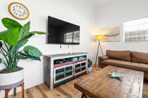 a living room with a flat screen tv on a wall at Pet Friendly Crystal River Retreat for the Family in Crystal River