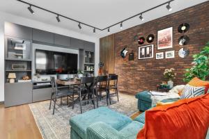 a living room with a brick wall at Entire House Free Parking Sleeps 26 MIT Harvard TD in Somerville