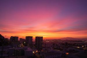 a view of a city at sunset at E1 Suites - Modern Comfort & Spa Luxury, Gibraltar in Gibraltar