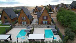 an aerial view of a house with two swimming pools at Casa Brava villas in Novoberdo