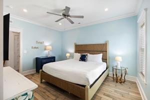 a bedroom with a bed and a ceiling fan at PALM2905: 2905 Palm Blvd. in Isle of Palms +49 photos