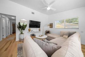 a living room with a couch and a tv at Drift & Dream Getaway Relax After Your Adventure with your Family in Crystal River
