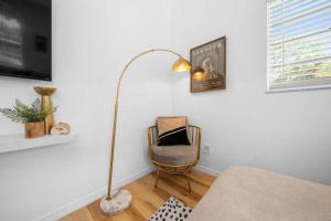 a living room with a floor lamp and a chair at Drift & Dream Getaway Relax After Your Adventure with your Family in Crystal River