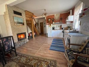 a kitchen with a stove and a fireplace at Agroturystyka Eden i Raj "Pod rzeźbami" in Krynki +24 photos