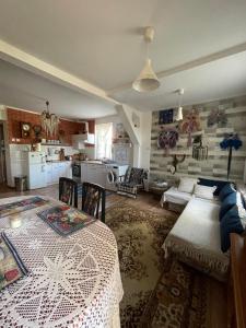 a large living room with a table and a kitchen at Agroturystyka Eden i Raj "Pod rzeźbami" in Krynki
