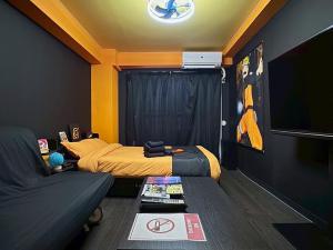 a small room with two beds and a couch at Dai2 Narumitsu Building 301 - Vacation STAY 29234v in Tokyo