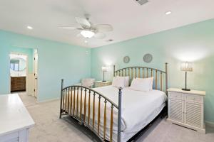 a bedroom with a bed and a ceiling fan at SG3C: 3C Seagrove Villa in Isle of Palms +27 photos