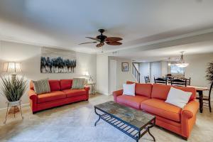 a living room with two red couches and a table at Stones Throw 30 in Hilton Head Island