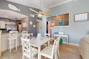 a dining room and kitchen with a table and chairs at Seas the Day in Port Aransas