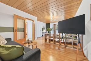 a living room with a couch and a flat screen tv at NEW-Tina in Buchen