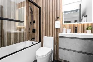 a bathroom with a toilet and a sink at Entire House Free Parking Sleeps 26 MIT Harvard TD in Somerville +149 photos