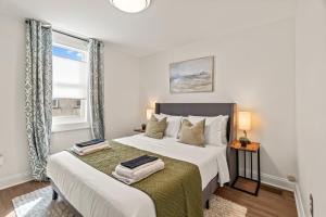 a bedroom with a large bed and a window at 3BR Gem in Graduate Hospital in Philadelphia