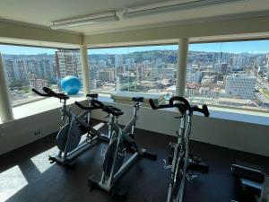 a gym with two bikes in front of a window at Steps from Everything in Viña del Mar