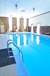 a large swimming pool with blue water in a building at Monarch Mountain Lodge in Monarch