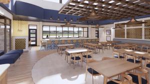 a restaurant with wooden tables and chairs and windows at Hotel Eastport in The Villages