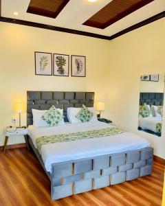 a bedroom with a large bed in a room at Umda Hotel Bazaar in Nathia Gali