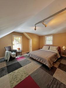 a bedroom with a large bed and a rug at Cozy retreat in Woodstock Perfect for Fall Foliage in Woodstock