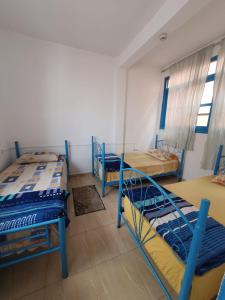 une chambre avec trois lits superposés dans l'établissement TISLIT Surf Taghazout, à Taghazout