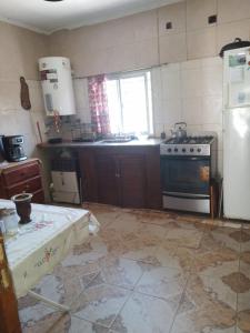 a kitchen with a stove and a refrigerator at Nuestro Paraiso in Mar del Plata