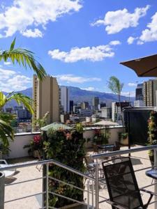 a balcony with a view of a city at Hotel California Medellin in Medellín