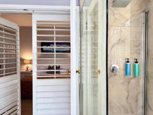 a walk in shower with a glass door at Musgrave Avenue Guest Lodge in Durban +74 photos