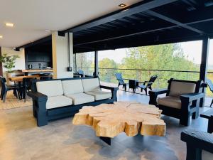 a living room with a couch and a table at Exclusive Villa - Lake View - Forest in La Pradera
