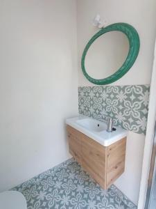 a bathroom with a sink and a mirror at Casa del arroyo in Caserío Arroyofrío +39 photos