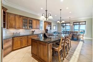 a large kitchen with wooden cabinets and a large island at OP58: 58 Ocean Point in Isle of Palms