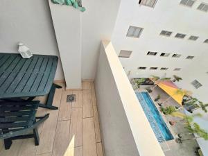 a view of a balcony with a table and an umbrella at Joli appartement Mohammédia in Mohammedia