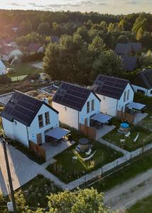 an aerial view of a house with solar panels on it at Domki przy Lesie Sasino in Sasino