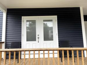 a front door of a house with two chairs at Wolfville Veranda Suite2 in Wolfville