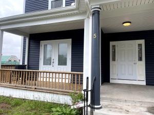a front porch of a house with a white door at Wolfville Veranda Suite2 in Wolfville