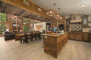 a large kitchen and dining room with a dining table at Wine Time 5 Bedroom Shuffleboard Hot Tub Fire Pit Play Set in Broken Bow +181 photos