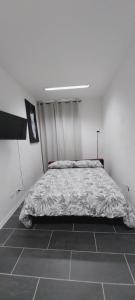 a bedroom with a bed in a white room at La Stella Bianca in Sutri