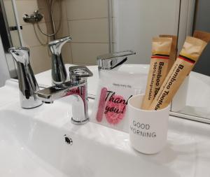a bathroom sink with two toothbrushes and a cup at La Stella Bianca in Sutri +16 photos