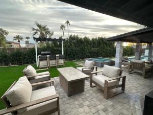a patio with chairs and a table and a pool at Arizona cozy place in Mesa