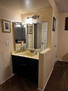 a bathroom with a sink and a large mirror at Arizona cozy place in Mesa +20 photos