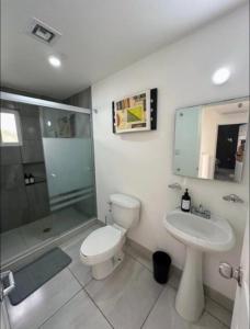 a bathroom with a toilet and a sink and a shower at Casa Privada en Zona Cantera in Chihuahua
