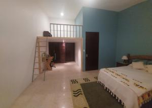 a bedroom with a bed and a room with a ladder at Casa en renta, fraccionamiento Victoria, Oaxaca in Oaxaca City