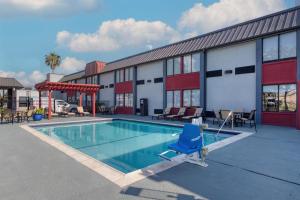 a swimming pool in front of a building at Best Western Webster Hotel, NASA in Webster